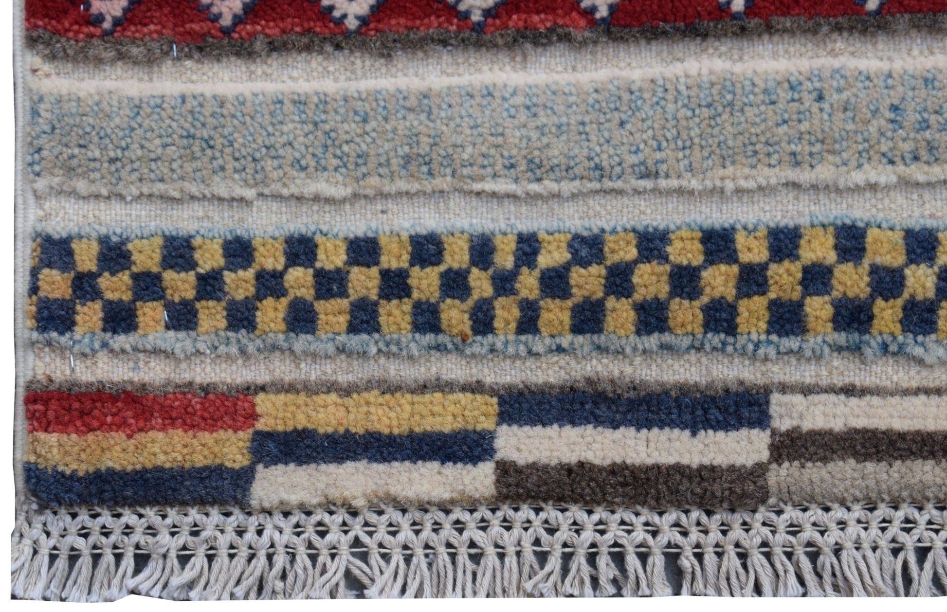 A handmade Afghan Yekta runner featuring geometric patterns in red, blue, yellow, and cream wool.