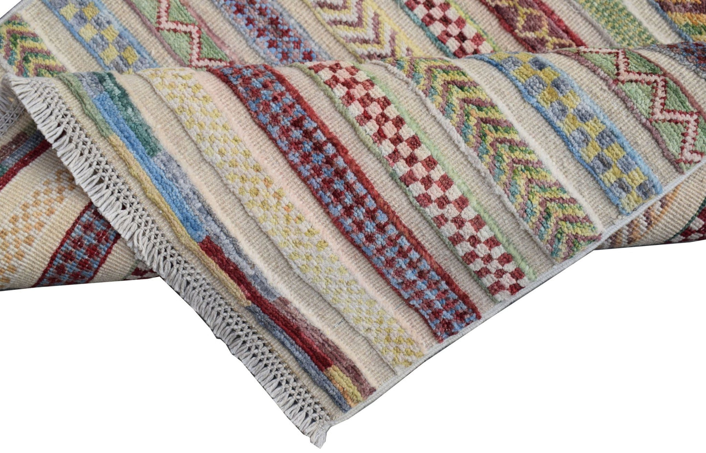 A handmade Afghan runner rug featuring a cream background with colorful geometric striped patterns.