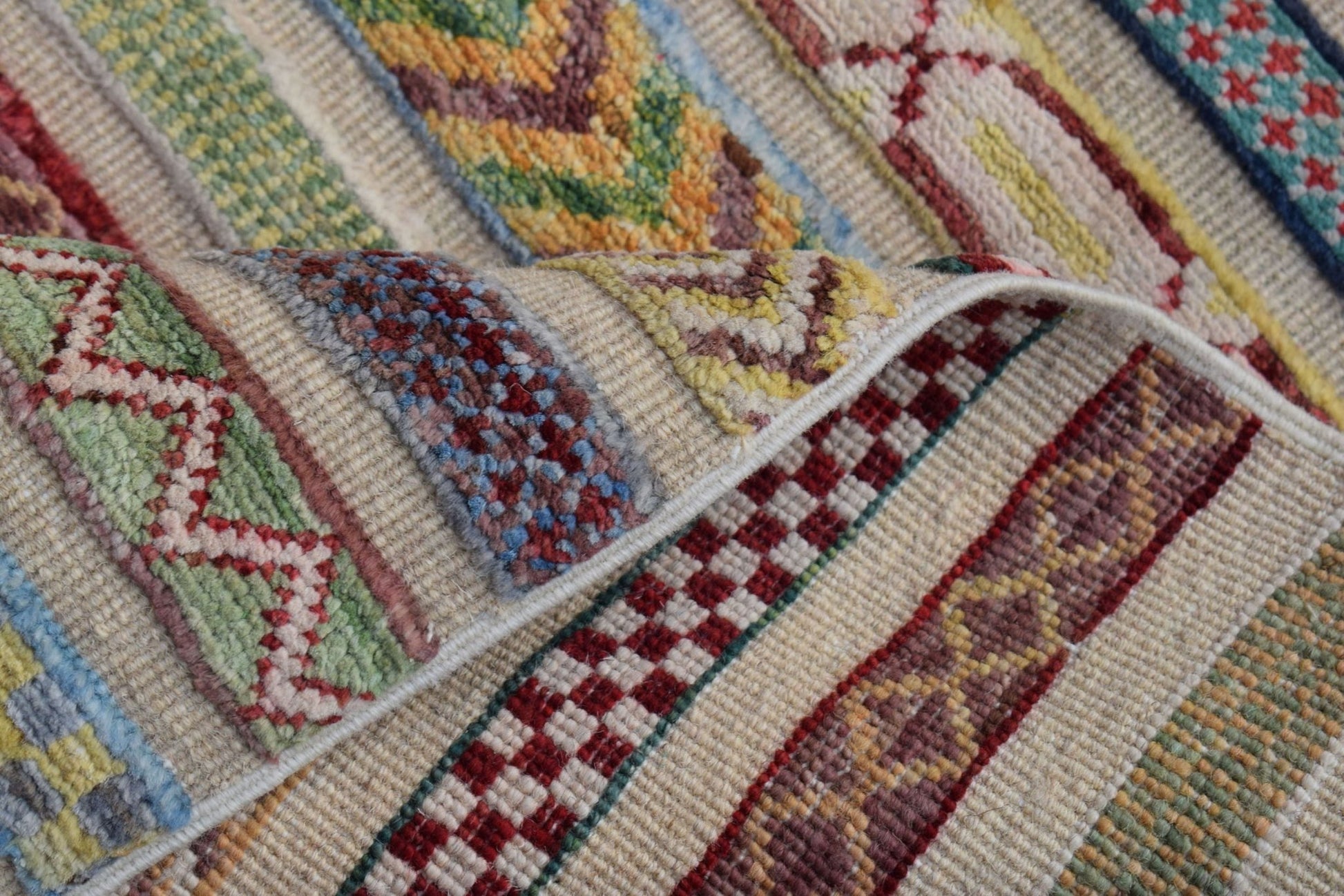 A handmade Afghan Yekta runner featuring a colorful, geometric striped pattern on a wool pile.