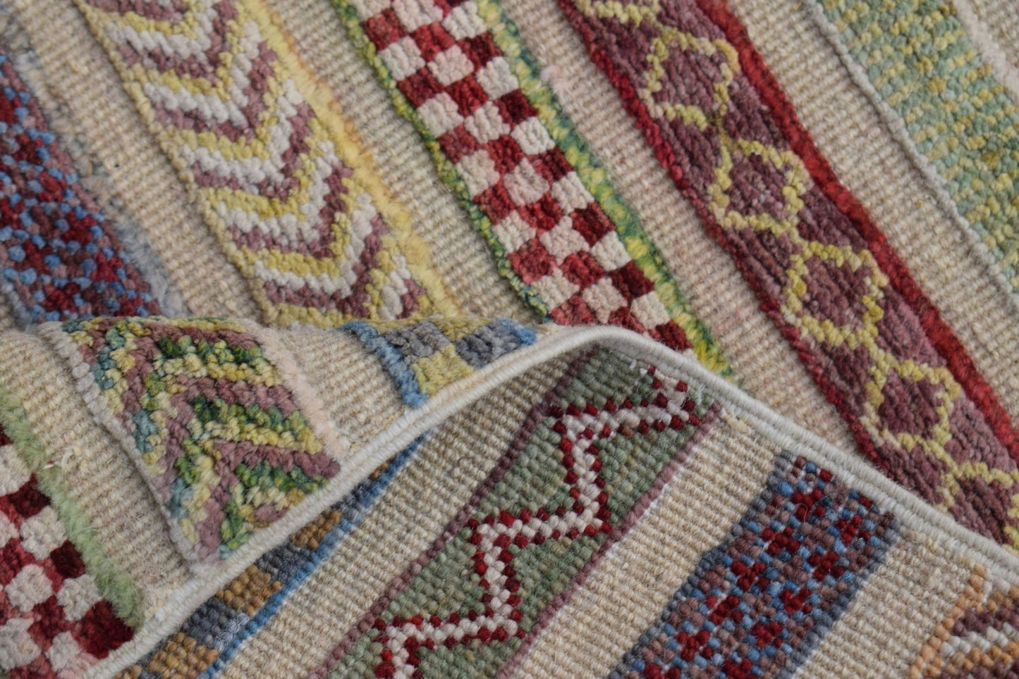 A handmade Afghan Yekta runner featuring a colorful striped pattern with geometric motifs.