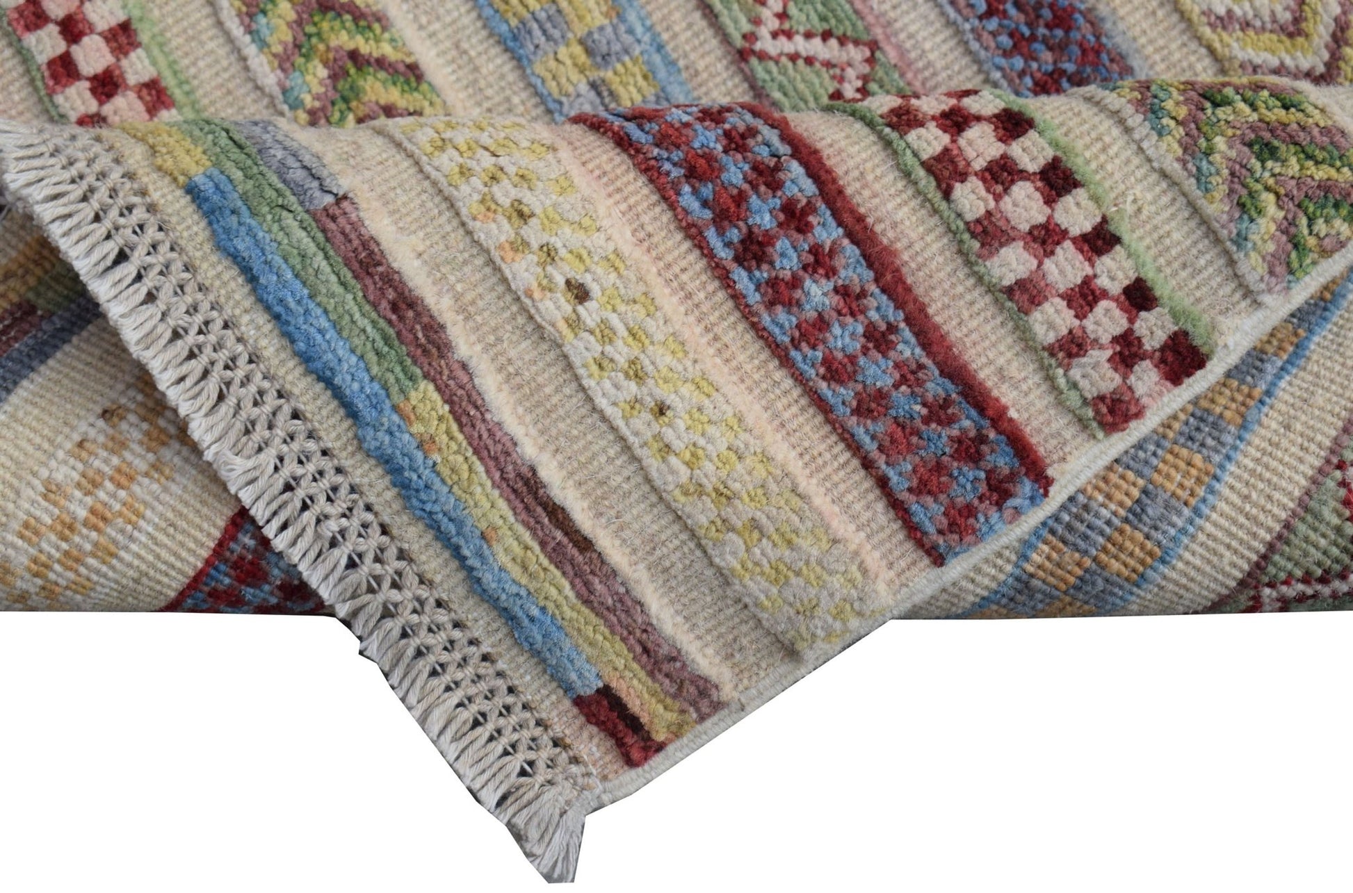 A handmade Afghan Yekta runner featuring colorful geometric patterns and a fringed edge.