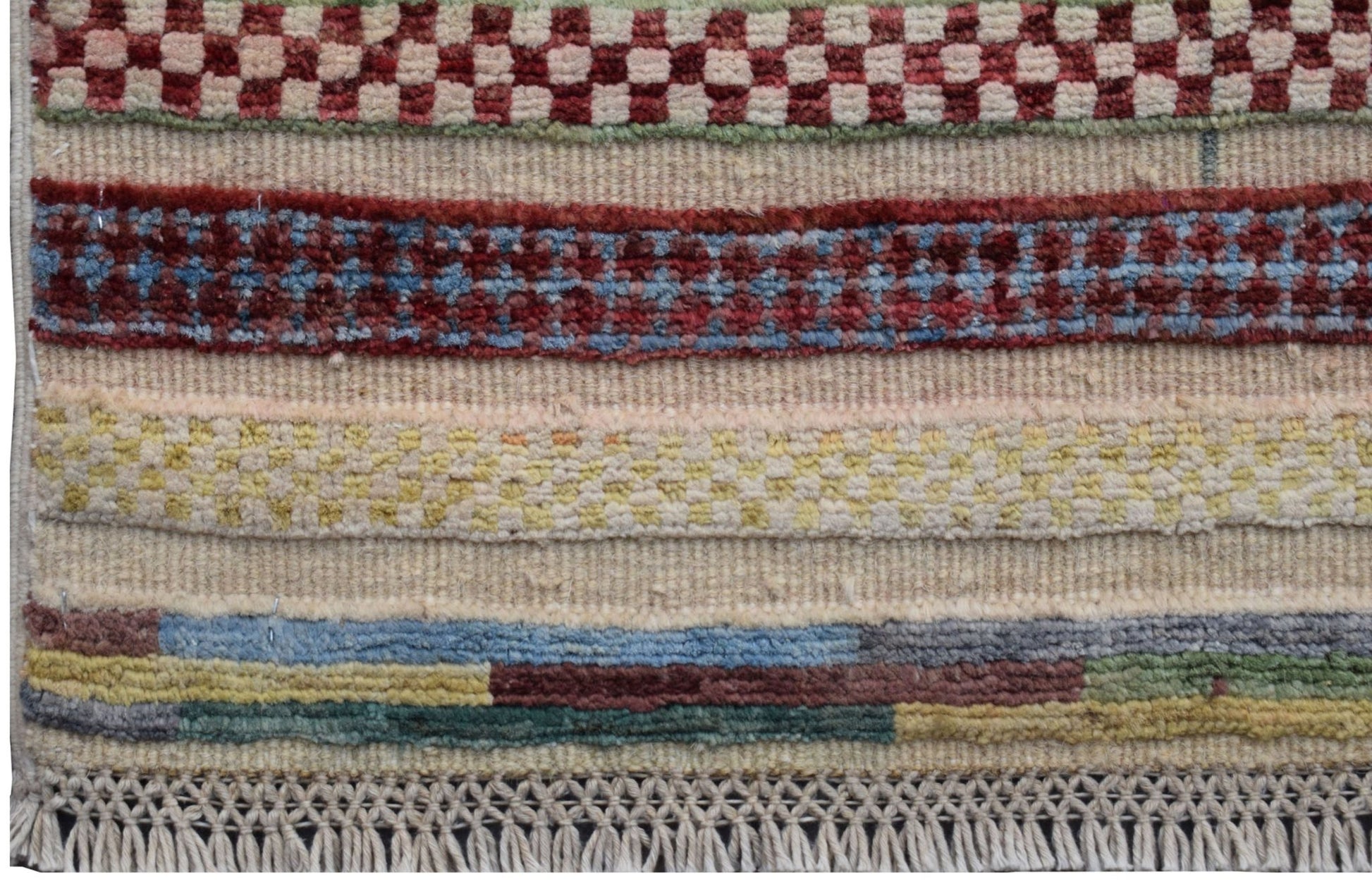 A handmade Afghan Yekta runner featuring horizontal bands of geometric patterns and colorful wool.