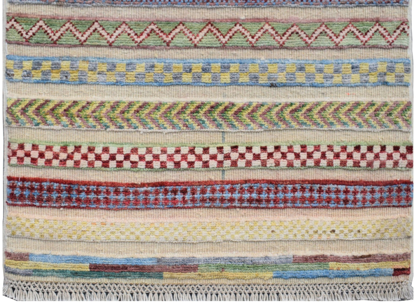 An Afghan Yekta runner featuring horizontal bands of colorful geometric and chevron patterns.