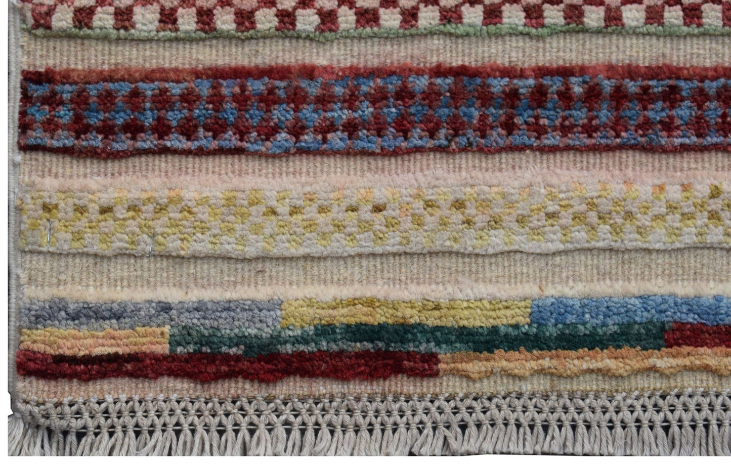 Handmade Afghan Yekta runner featuring horizontal bands of colorful geometric patterns and fringe.