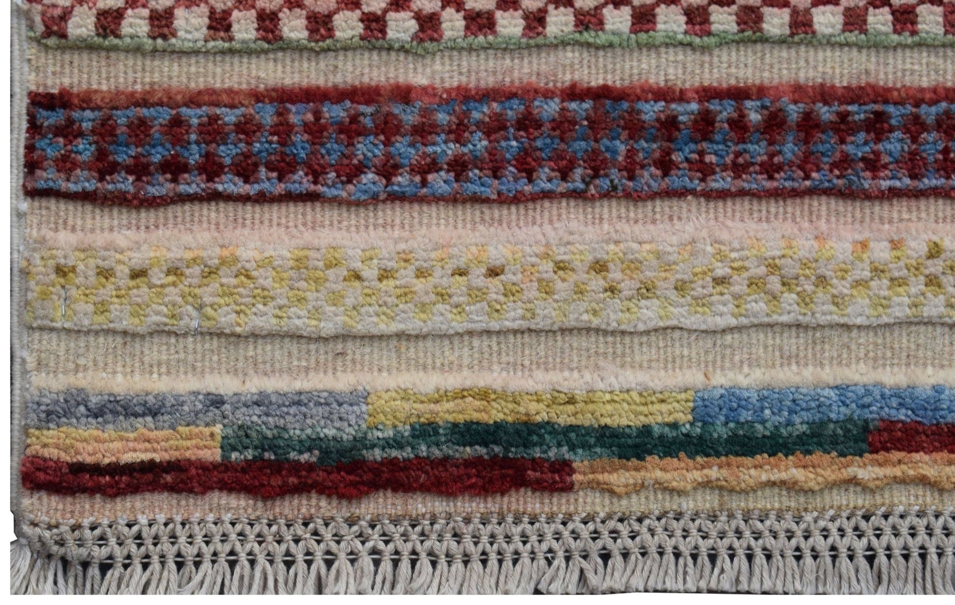 Handmade Afghan Yekta runner featuring horizontal bands of colorful geometric patterns and fringe.