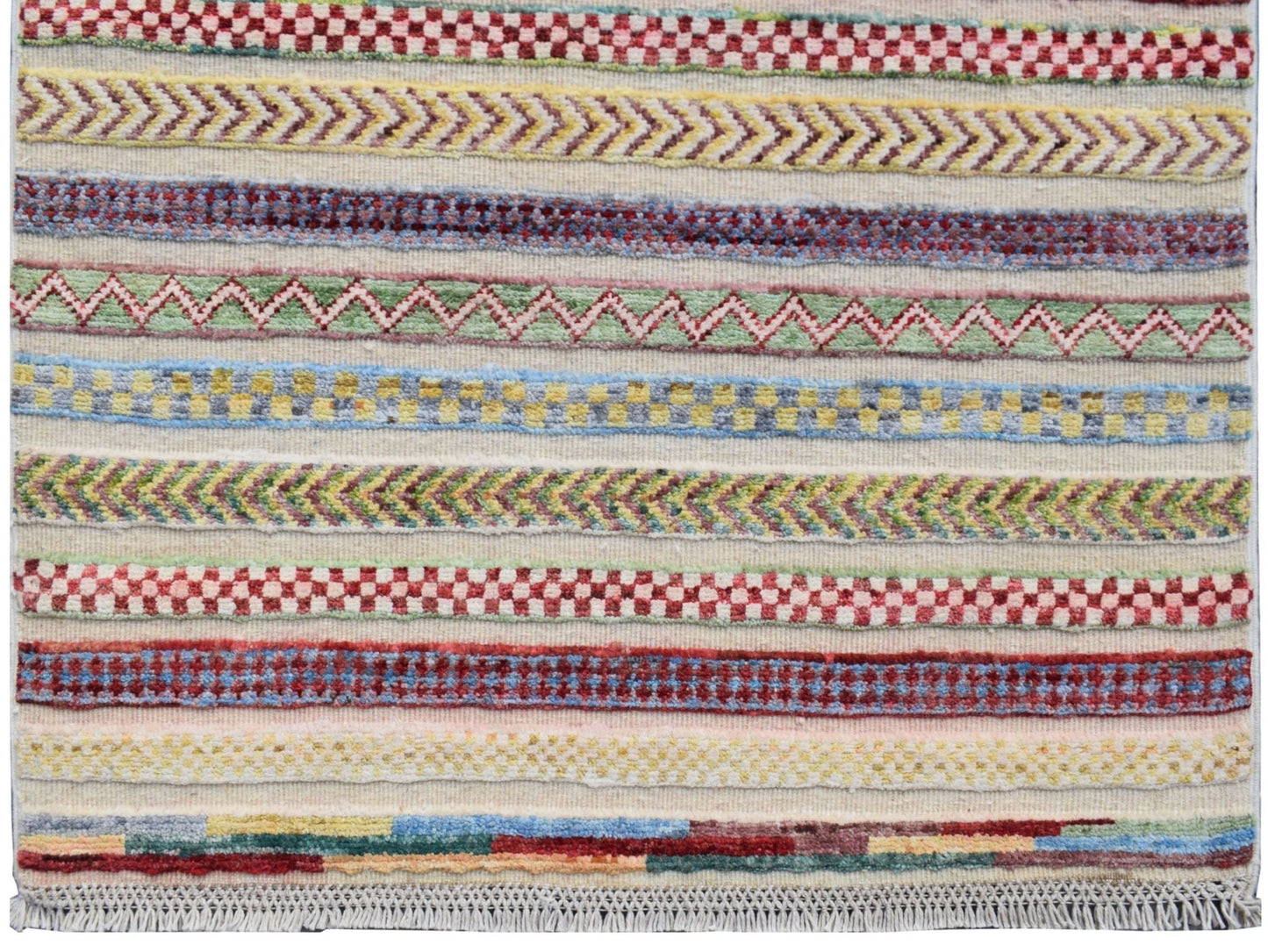 Handmade Afghan runner rug featuring horizontal bands of colorful geometric and chevron patterns.