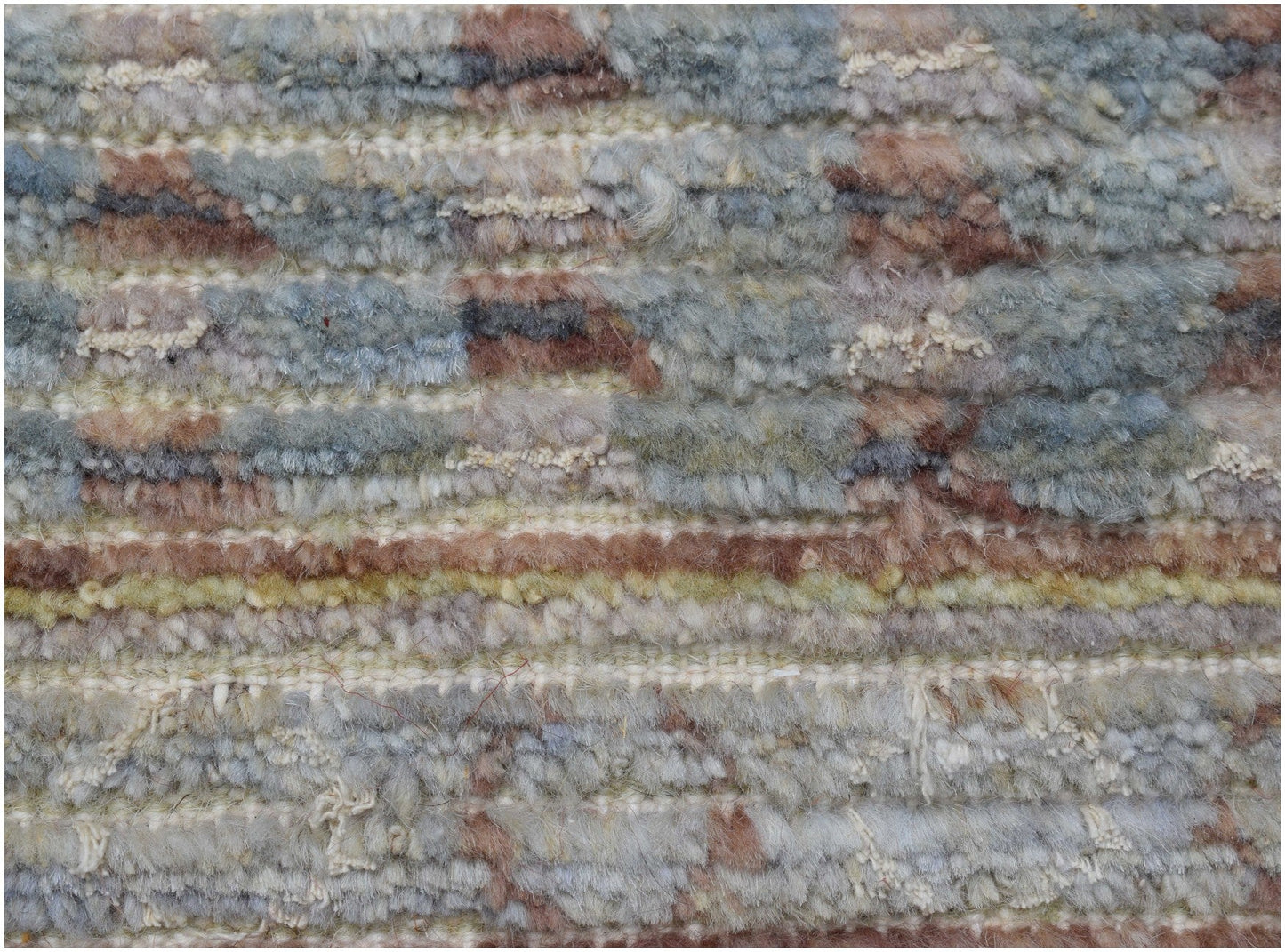 A handmade Afghan Yekta rug featuring a textured blend of wool in earthy blue and brown tones.