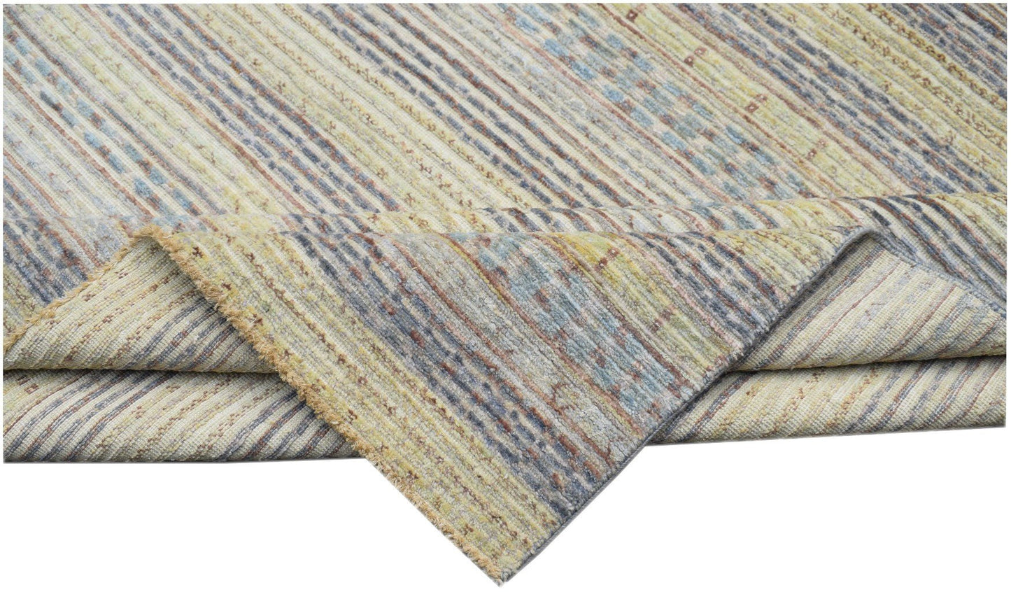 An Afghan Yekta rug featuring a textured, striped pattern in muted yellow, blue, and grey tones.