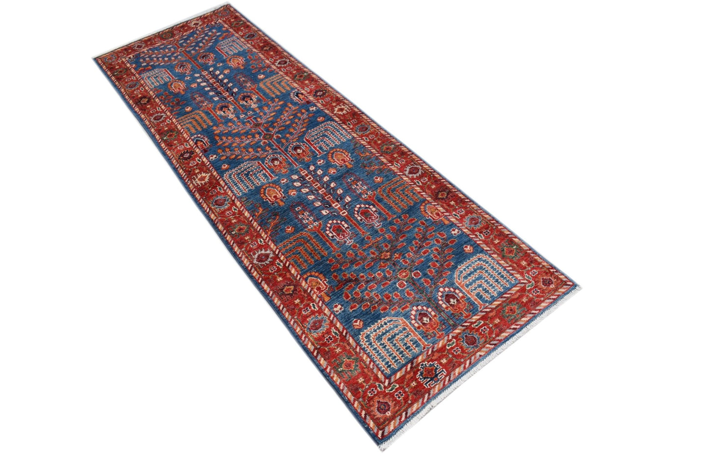 A handmade Afghan Chobi runner rug featuring a traditional blue and red geometric pattern.