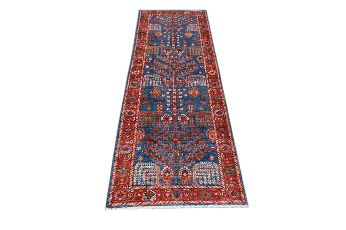 An Afghan Chobi runner rug featuring a traditional blue field with intricate red floral patterns.