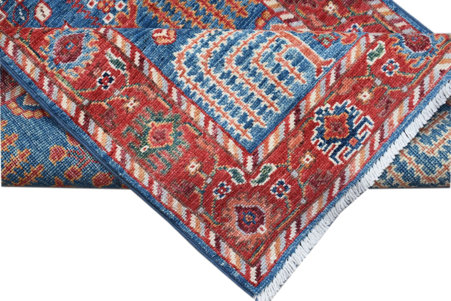 A handwoven Afghan Chobi runner featuring a traditional geometric pattern in red and blue tones.