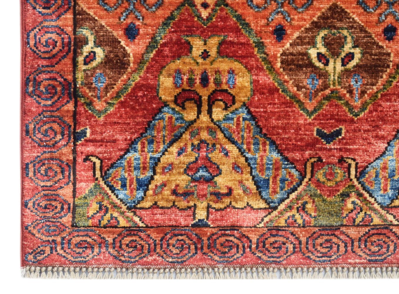A handmade Afghan Chobi runner featuring traditional geometric patterns in red, blue, and gold.