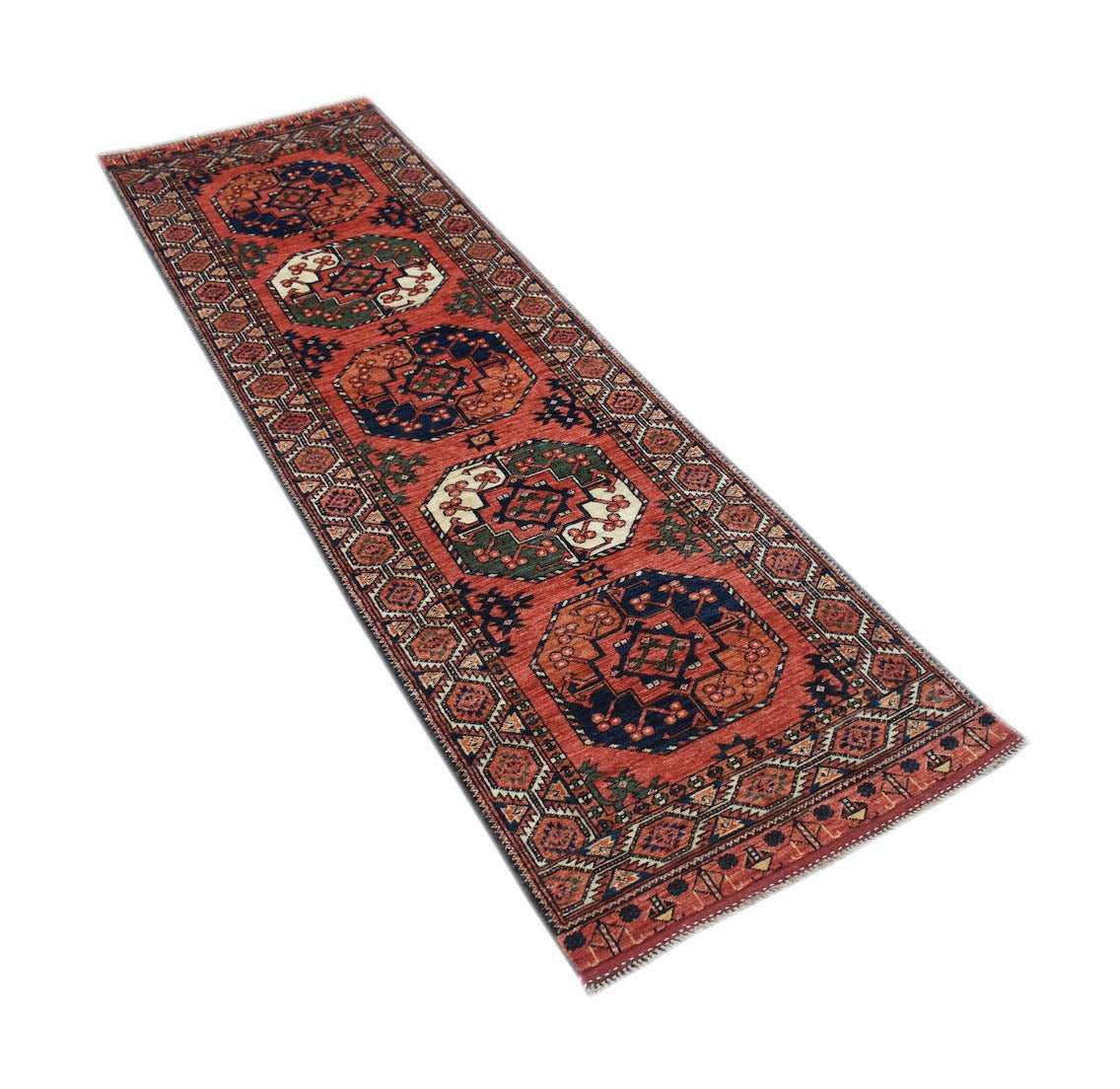 An Afghan Chobi runner rug featuring geometric medallions in red, blue, and green wool.