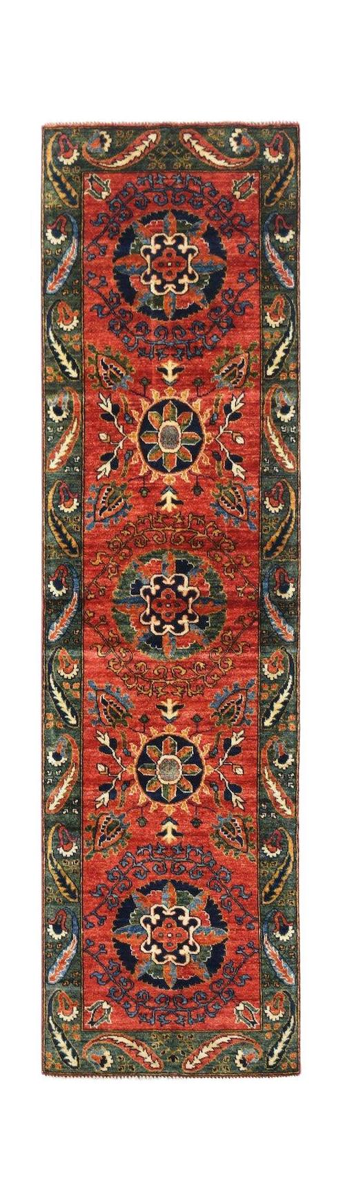 A handmade Afghan Chobi runner rug featuring traditional floral motifs in red, blue, and green.