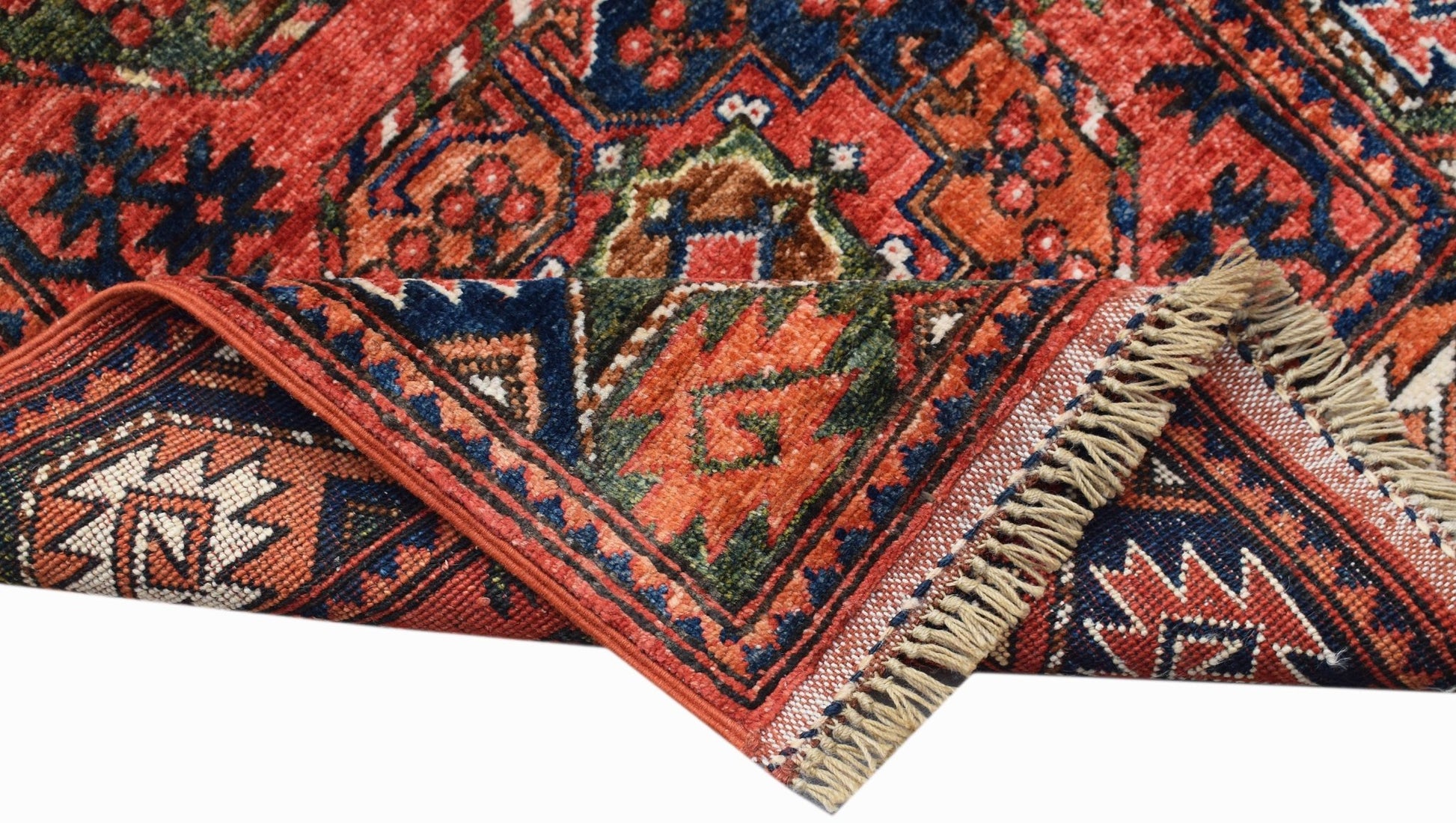 A handwoven Afghan Chobi runner featuring a traditional geometric pattern in red and blue wool.