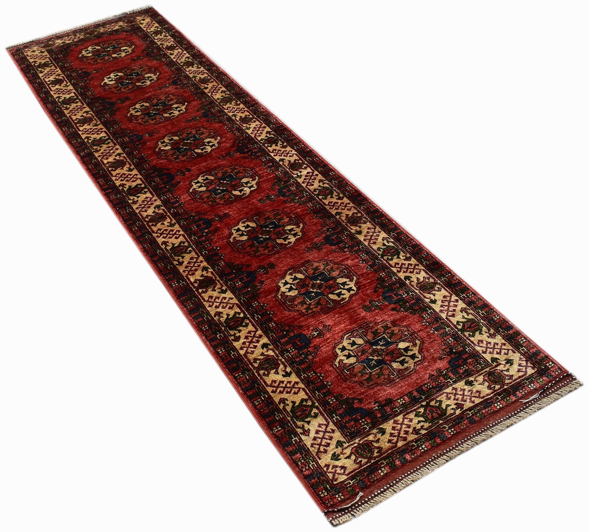 A handmade Afghan Chobi runner rug featuring traditional geometric patterns in red and beige tones.