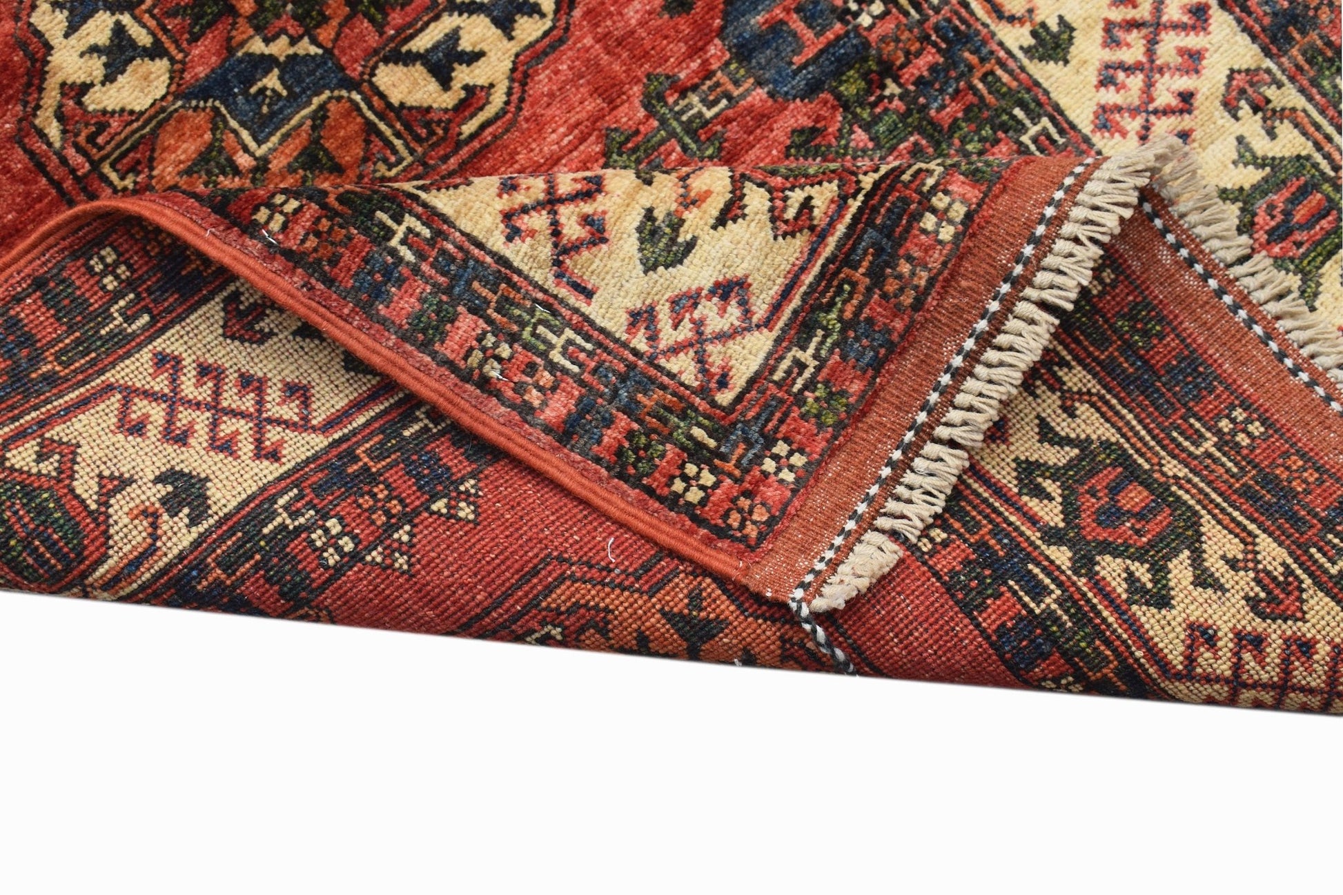 A handwoven Afghan Chobi runner featuring traditional geometric patterns in red and cream tones.