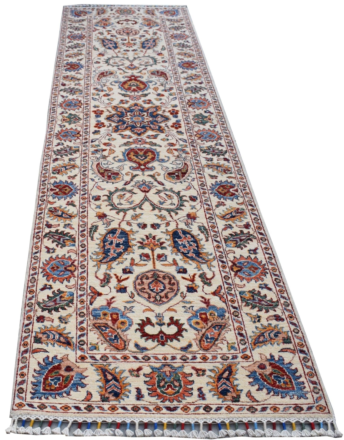 A handmade Afghan Chobi runner rug featuring a traditional Suzani floral pattern in vibrant colors.