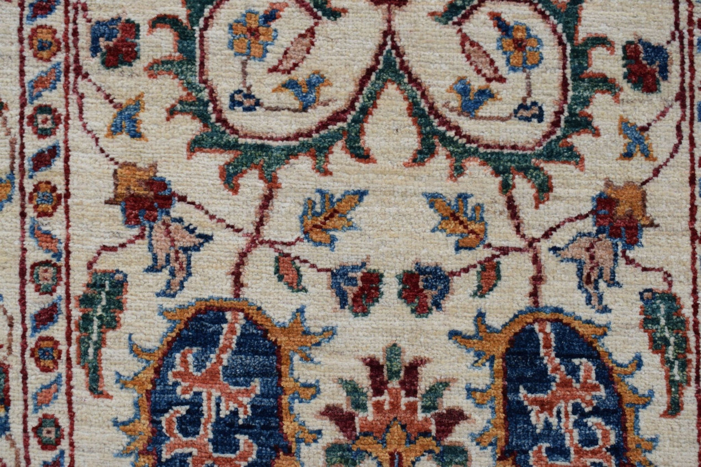 A handmade Afghan Chobi runner featuring intricate floral patterns in blue, red, and gold tones.