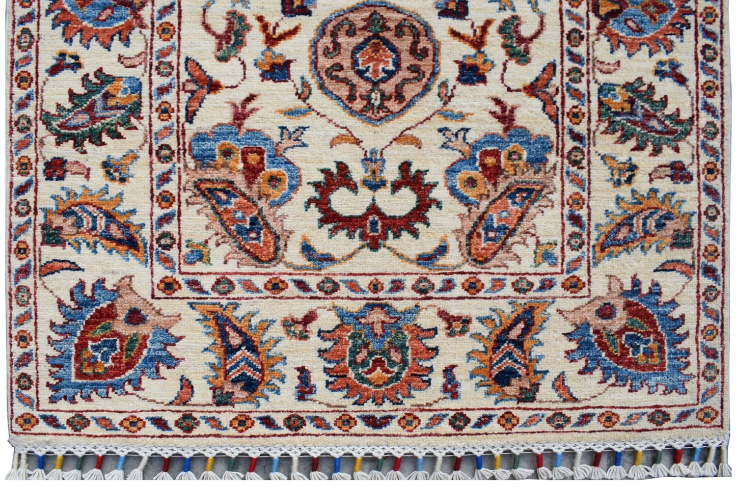 Handmade Afghan Chobi runner rug featuring traditional floral patterns in a cream color palette.
