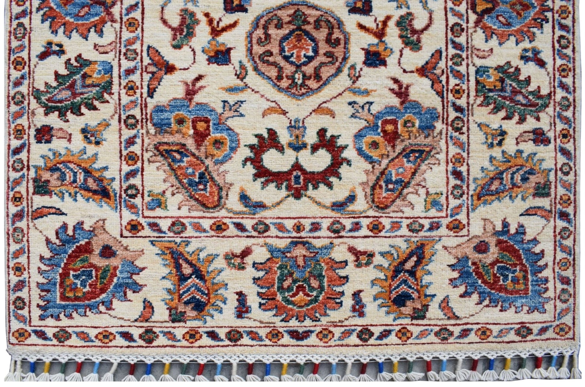 Handmade Afghan Chobi runner rug featuring traditional floral patterns in a cream color palette.