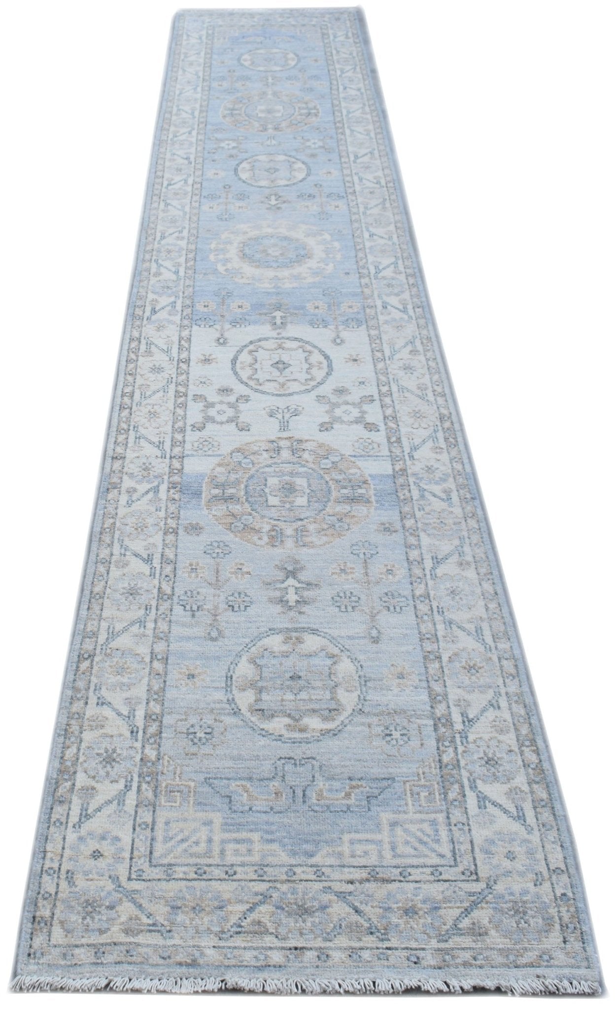 An Afghan Chobi runner rug featuring traditional circular motifs in shades of blue and beige.