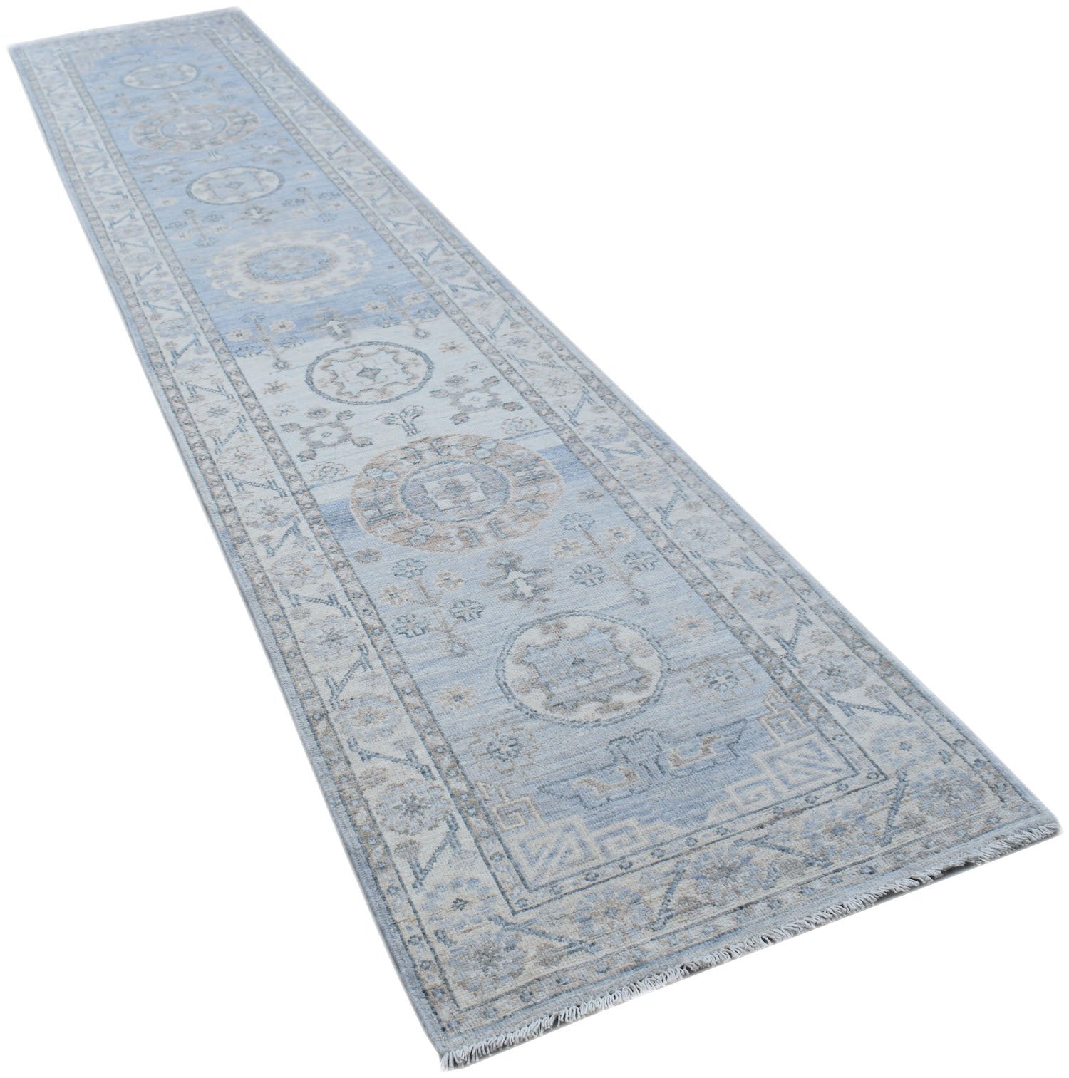 A long, handmade Afghan Chobi runner rug featuring traditional patterns in shades of blue and beige.