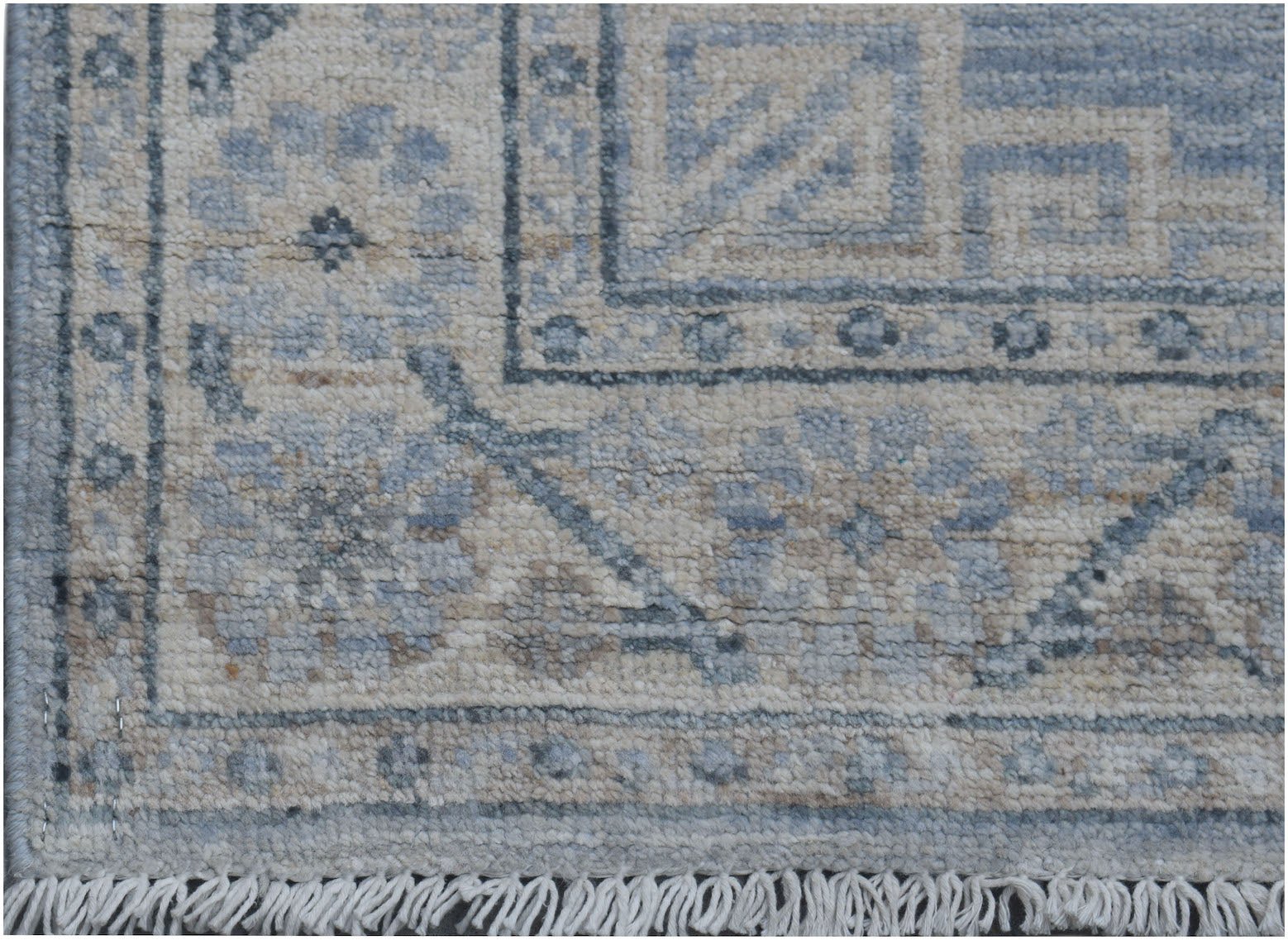 A handmade Afghan Chobi runner featuring a traditional floral pattern in soft blue and beige tones.