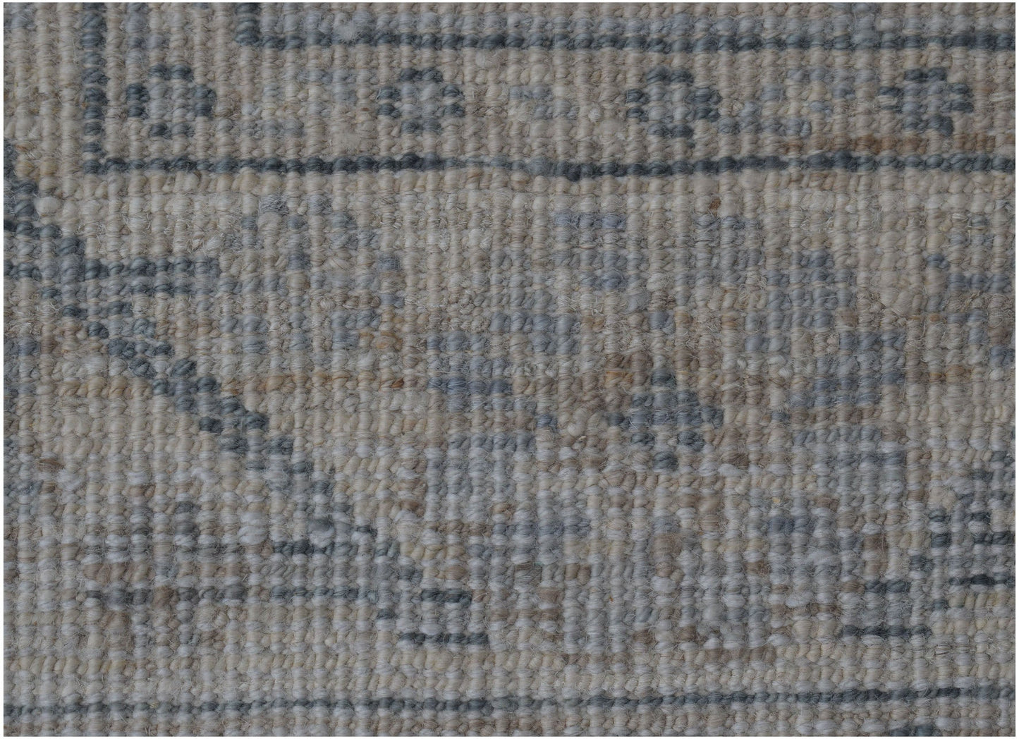A close-up of an Afghan Chobi runner featuring a traditional pattern in muted grey and beige tones.