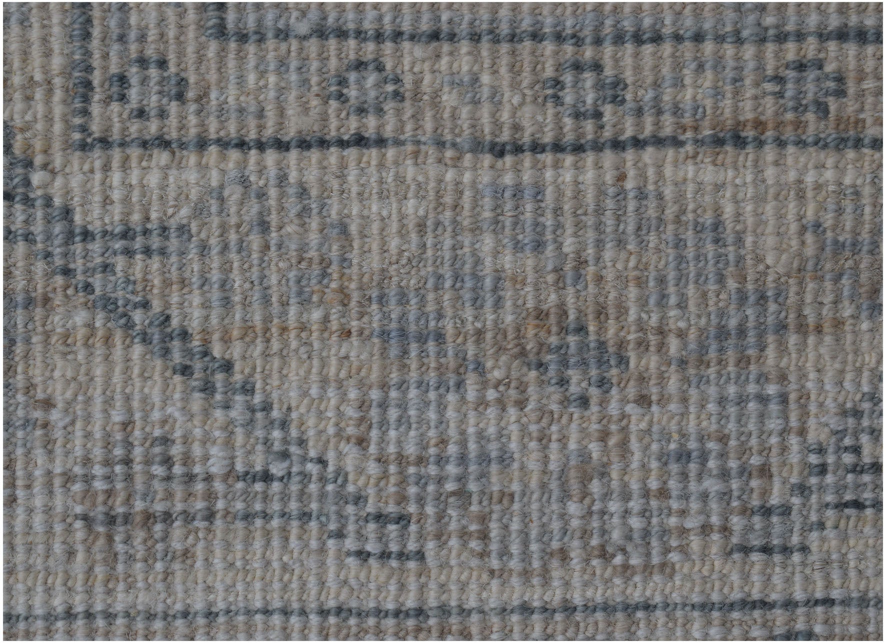 A close-up of an Afghan Chobi runner featuring a traditional pattern in muted grey and beige tones.