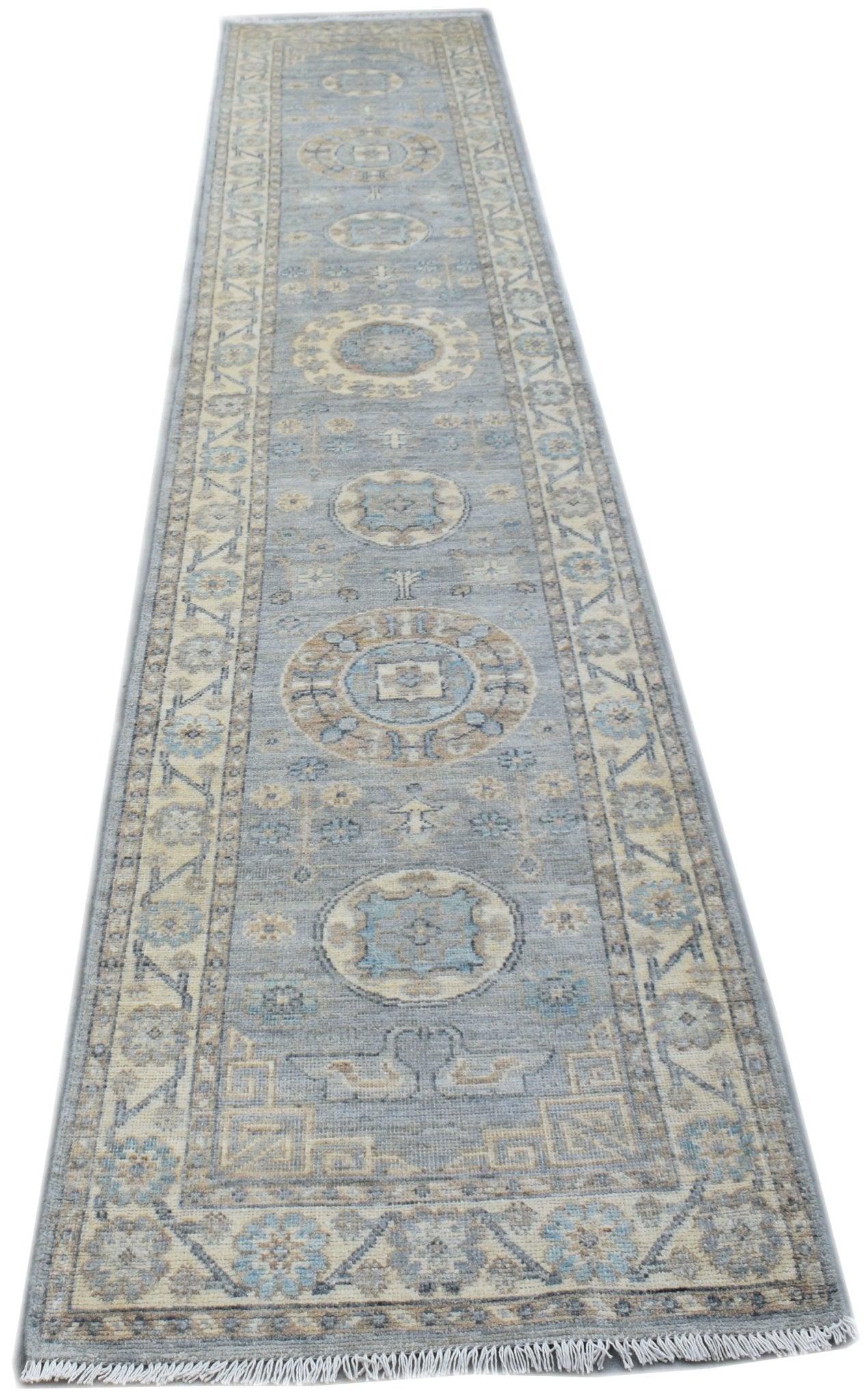A handmade Afghan Chobi runner rug featuring traditional geometric patterns in shades of blue and beige.