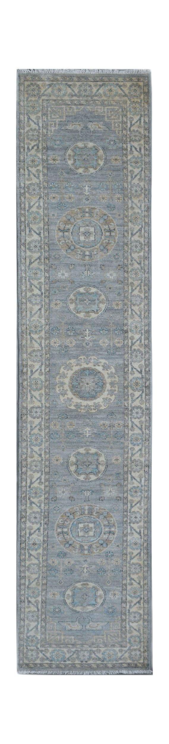 A handmade Afghan Chobi runner rug featuring traditional medallion patterns in shades of blue.