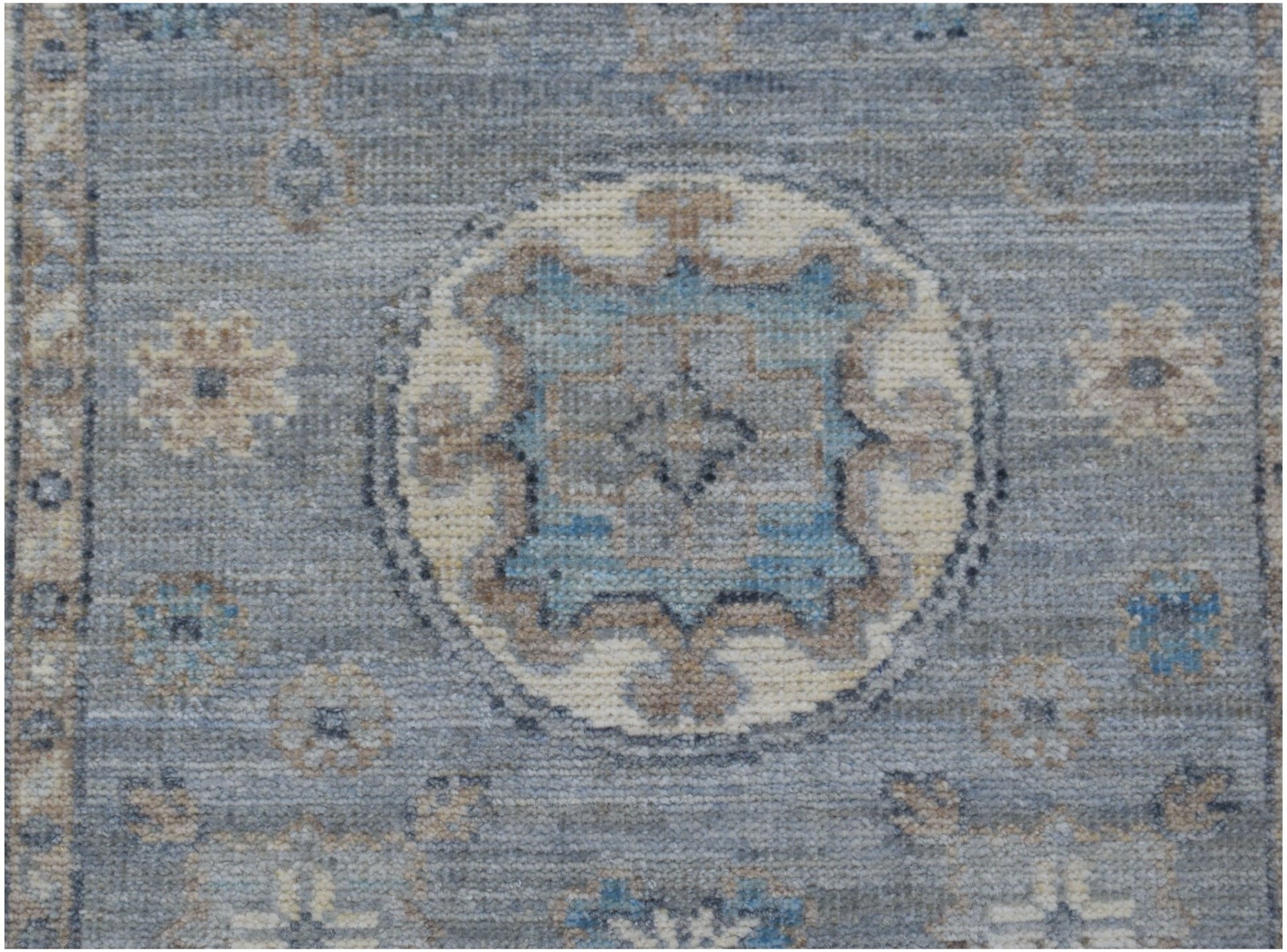 A handmade Afghan Chobi runner featuring a traditional blue and beige geometric medallion pattern.