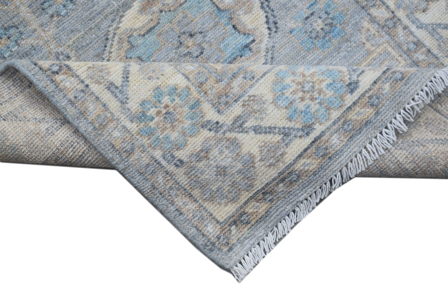 A handmade Afghan Chobi runner featuring a traditional blue and beige floral pattern.