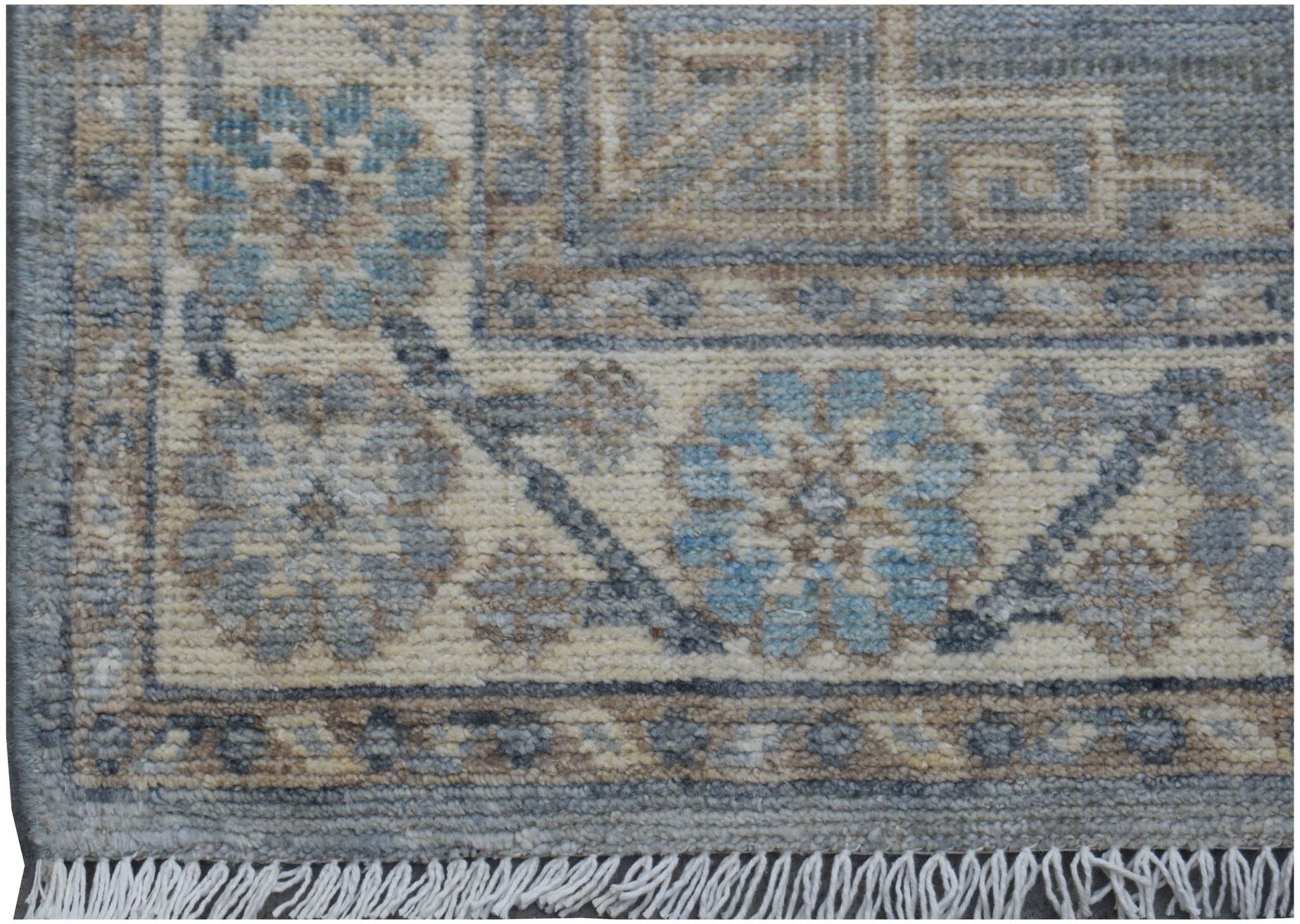 A handmade Afghan Chobi runner featuring a traditional floral pattern in blue and beige tones.
