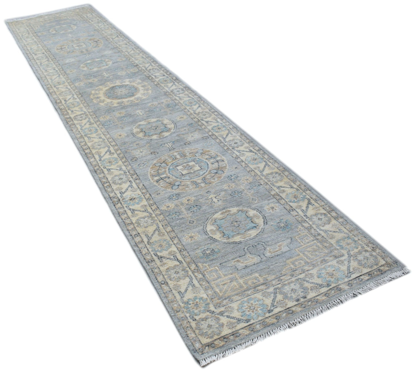 A handmade Afghan Chobi runner rug featuring traditional patterns in shades of blue and beige.