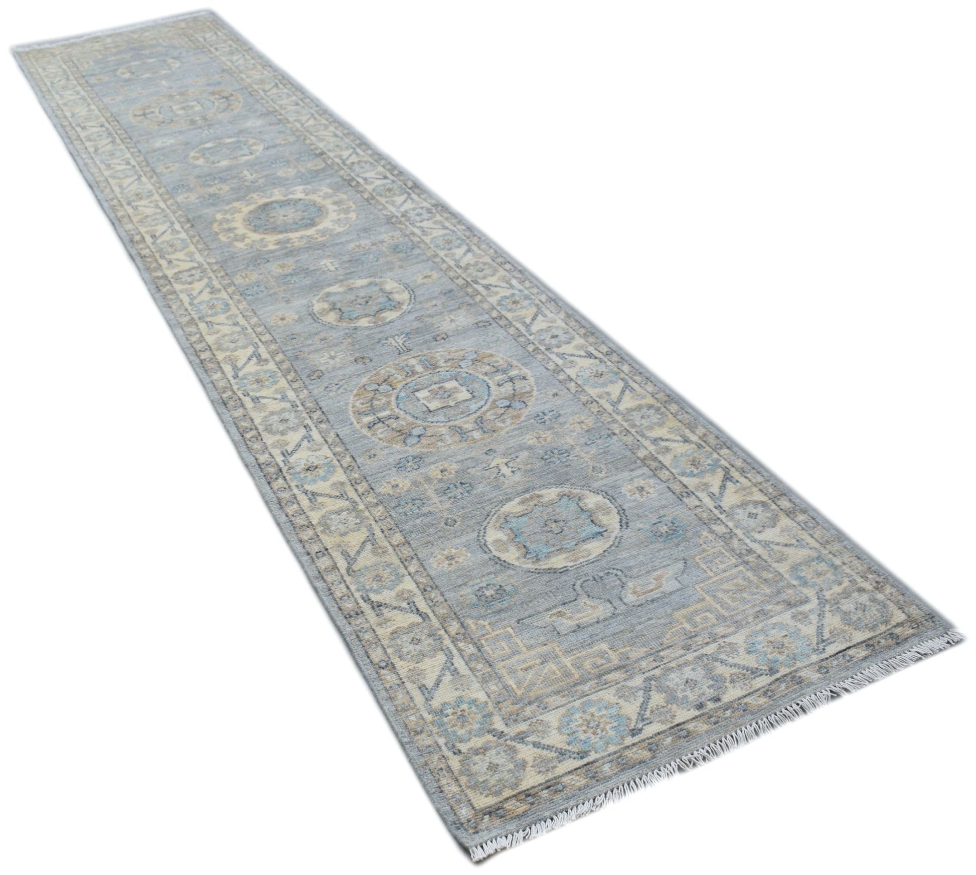 A handmade Afghan Chobi runner rug featuring traditional patterns in shades of blue and beige.