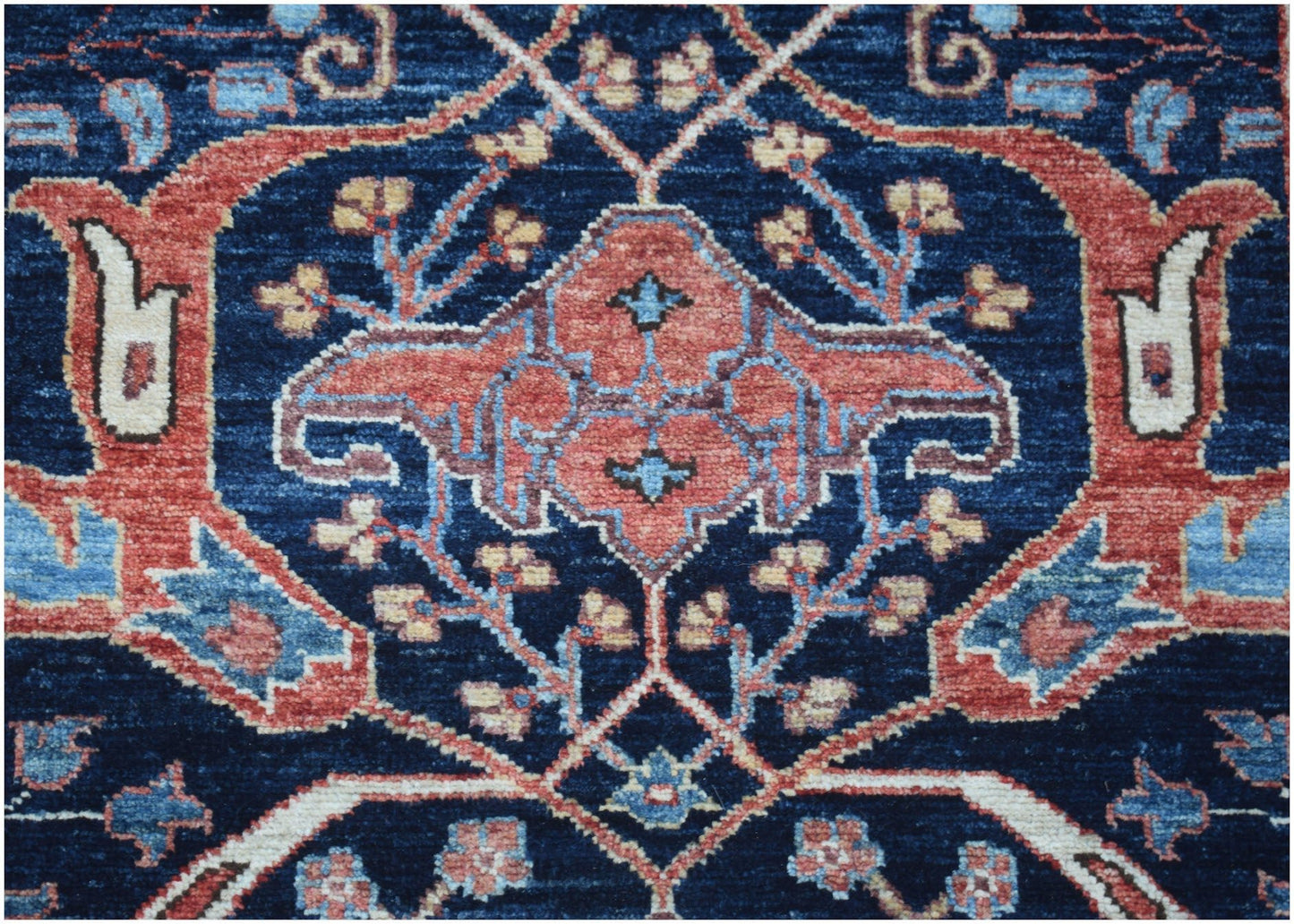 A close-up of an Afghan Chobi runner featuring a traditional floral pattern in blue and red tones.