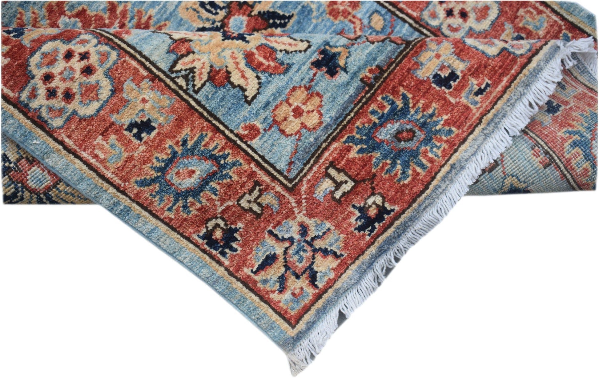 A handmade Afghan Chobi runner featuring a traditional floral pattern in blue and red tones.