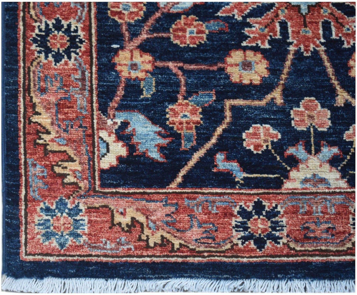 A handmade Afghan Chobi runner featuring a traditional floral pattern in red and blue tones.
