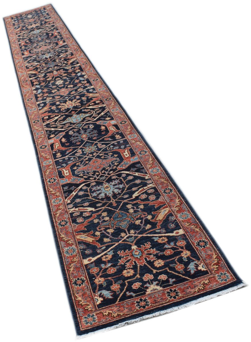 A long, handmade Afghan Chobi runner rug featuring a traditional floral pattern in earthy tones.
