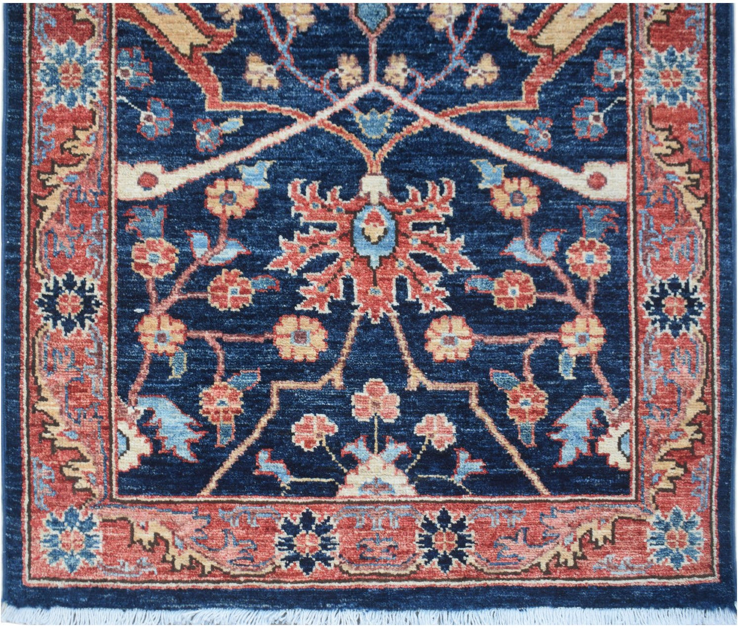 A handmade Afghan Chobi runner featuring a traditional floral pattern in blue, red, and beige.