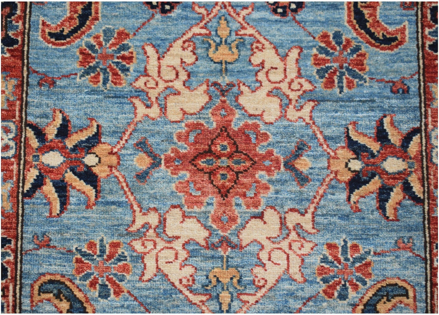 An Afghan Chobi runner rug featuring a traditional floral pattern in red, blue, and cream tones.
