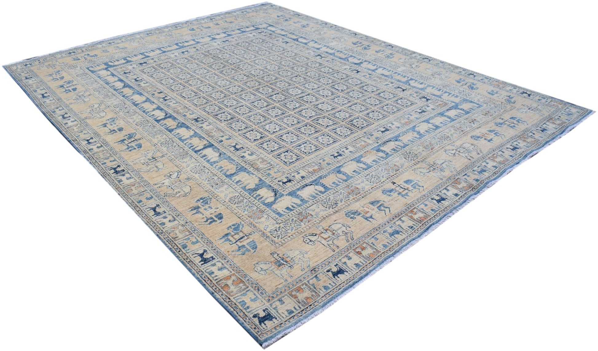 A handmade Afghan Chobi rug featuring a Pazyryk-inspired grid pattern with blue and beige tones.