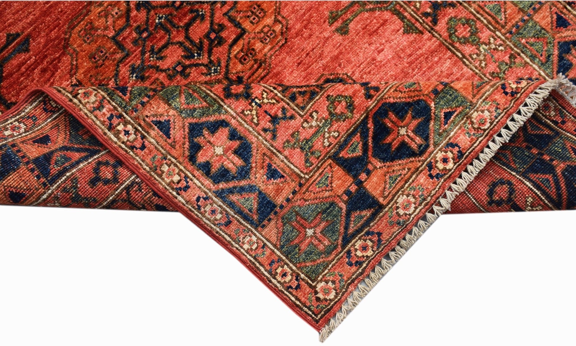 A handwoven Afghan Chobi rug featuring traditional geometric patterns in red, blue, and green.