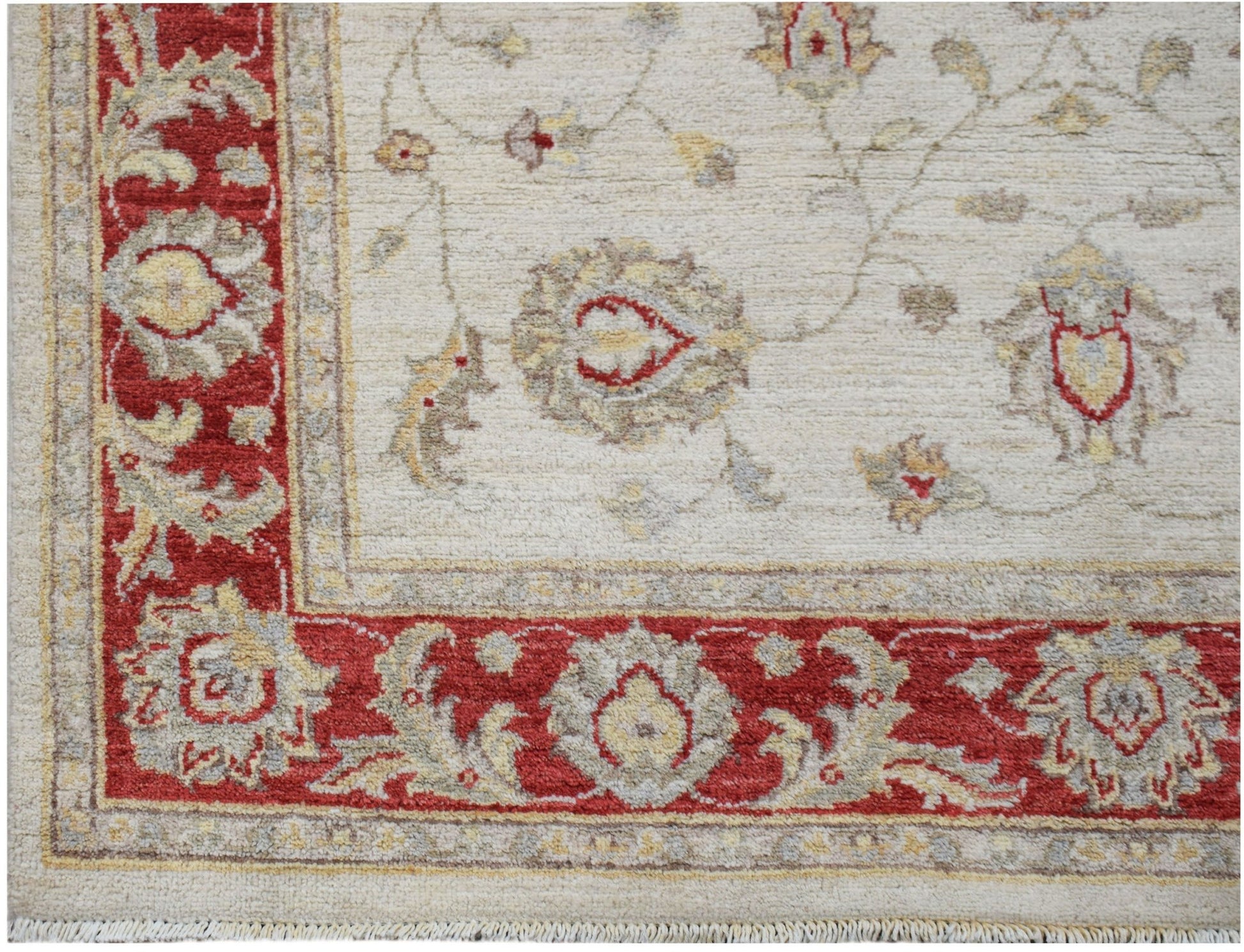 A handmade Afghan Chobi rug featuring a cream field with red floral borders and intricate patterns.