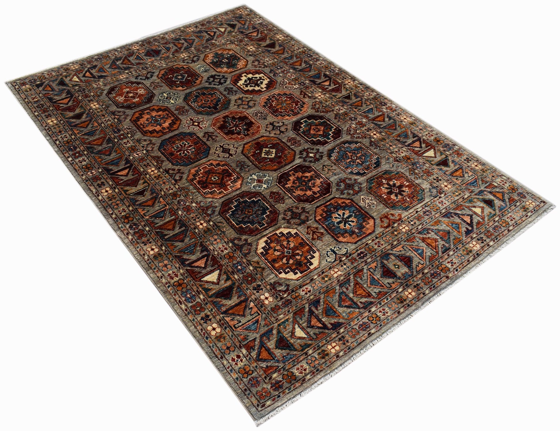 A rectangular Afghan Chobi rug featuring geometric octagonal motifs in earthy tones on a grey field.