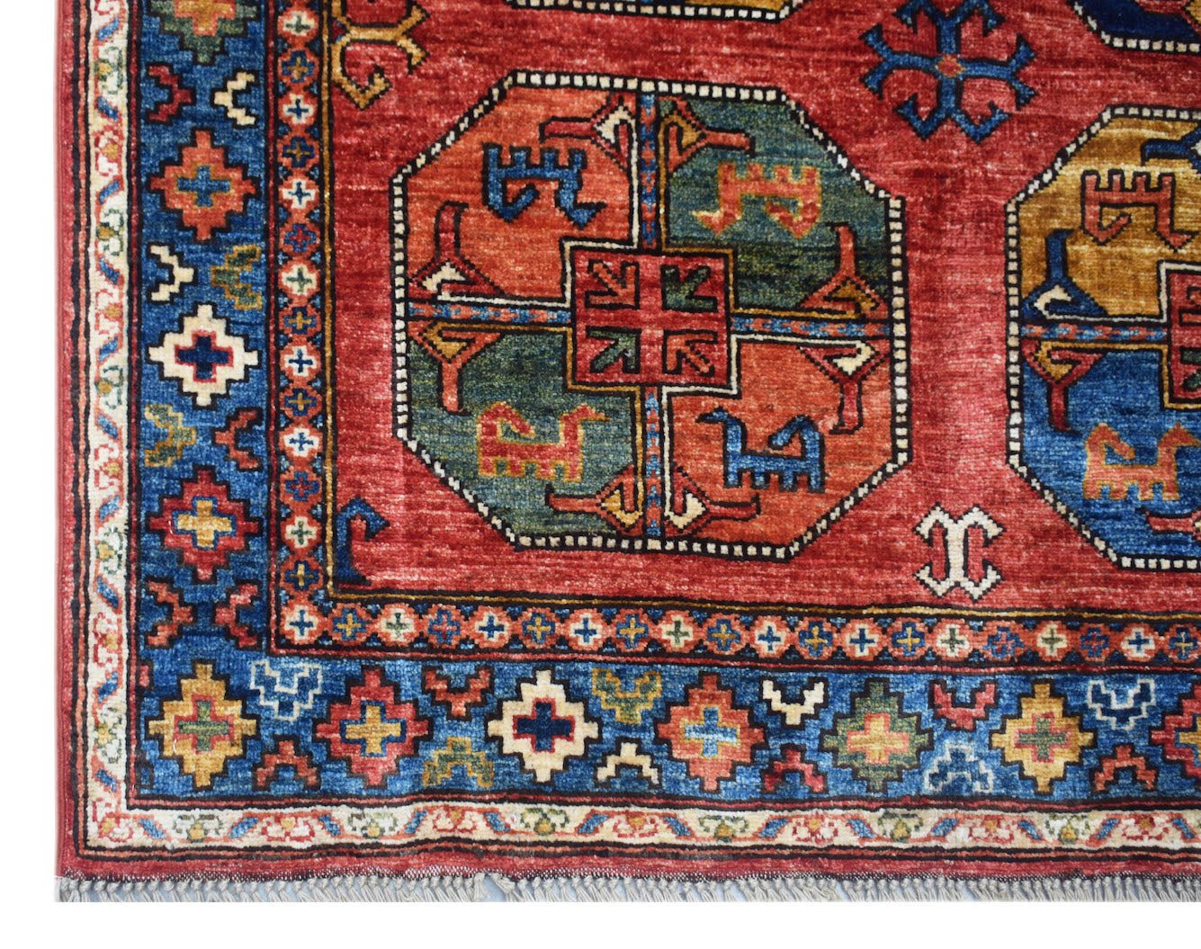 Handmade Afghan Chobi rug featuring a red field with geometric medallions and a blue border.