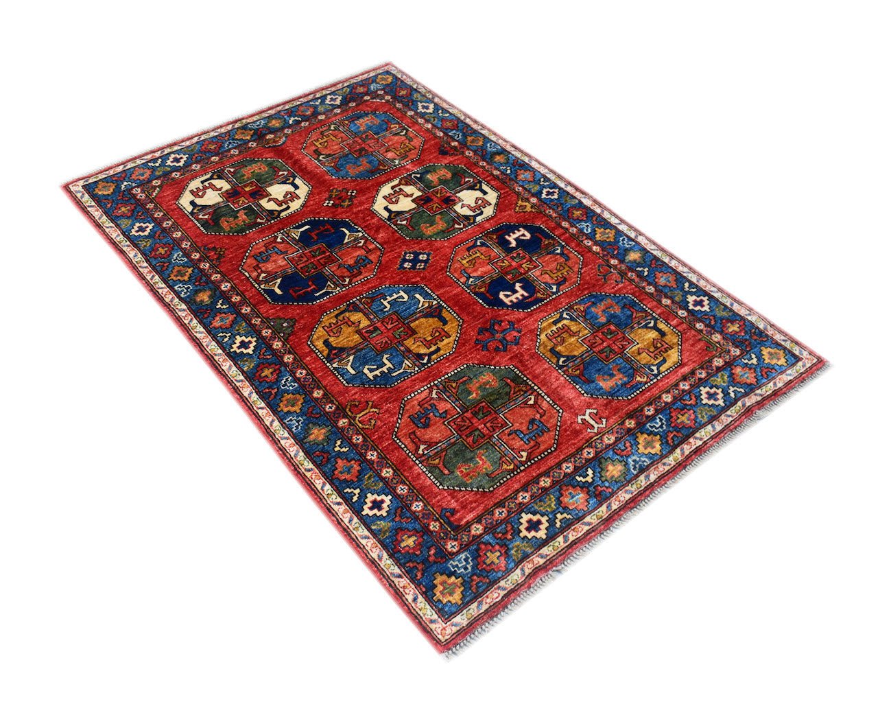 A rectangular Afghan Chobi rug featuring geometric medallions in a red field with a blue border.
