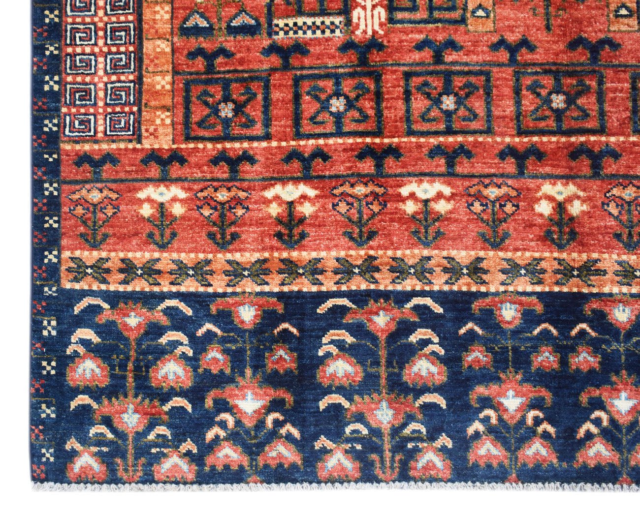 Handwoven Afghan Chobi rug featuring traditional floral patterns in red and blue wool.